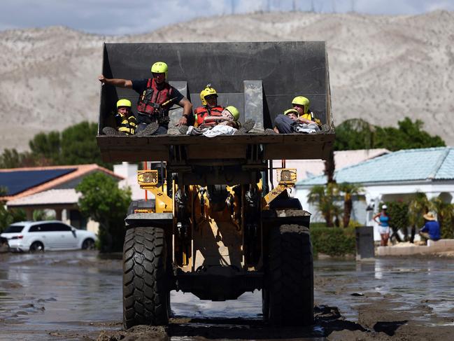 Elderly residents are rescued by members of the Cathedral City Fire Department in a bulldozer in Cathedral City, California. Picture: Getty Images/AFP