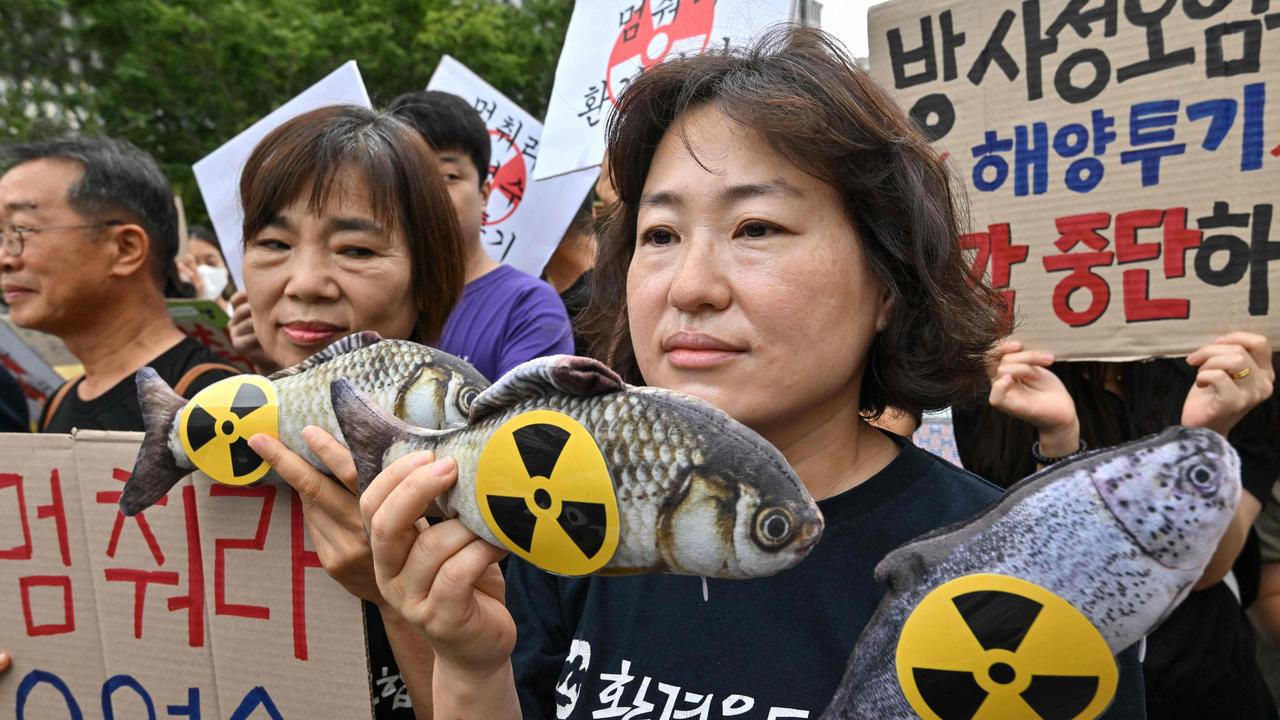 South Korean activists held ‘radioactive’ fish in a demonstration in Seoul. Picture: Jung Yeon-je / AFP.