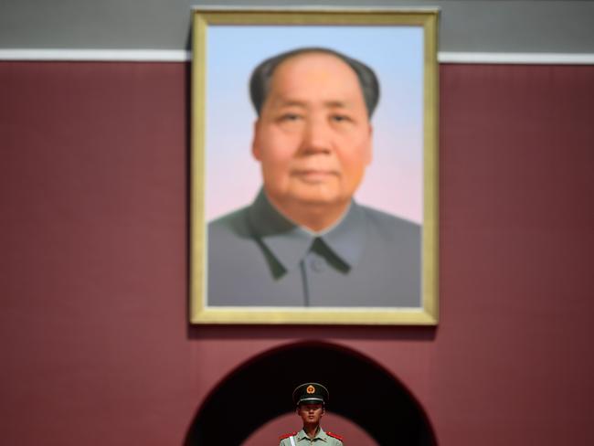 TOPSHOT - A Chinese paramilitary policeman stands in front of a portrait of late communist leader Mao Zedong at Tiananmen Gate in Beijing on September 20, 2019. (Photo by NOEL CELIS / AFP)