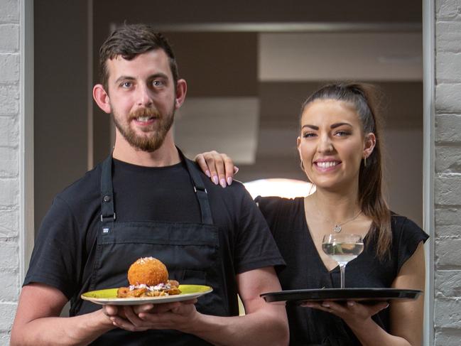 ADELAIDE, AUSTRALIA - Advertiser Photos NOVEMBER 18, 2022: Brompton Hotel, Chef Andrew Wandless holds his signature Chicken Kiev job and Duty Manager Emmy Thomson with the Brompton special Martini. The heritage-listed building which has undergone a year-long renovation by the Duxton Group, GALLETLYPicture : Emma Brasier