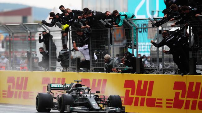 ISTANBUL, TURKEY - NOVEMBER 15: Mercedes team members celebrate on the pitwall as Lewis Hamilton of Great Britain driving the (44) Mercedes AMG Petronas F1 Team Mercedes W11 crosses the finish line to win during the F1 Grand Prix of Turkey at Intercity Istanbul Park on November 15, 2020 in Istanbul, Turkey. (Photo by Tolga Bozoglu - Pool/Getty Images)