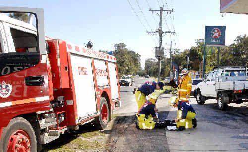 Firefighters monitor petrol vapour levels on Byron Street at Lennox Head yesterday. Picture: Cathy Adams