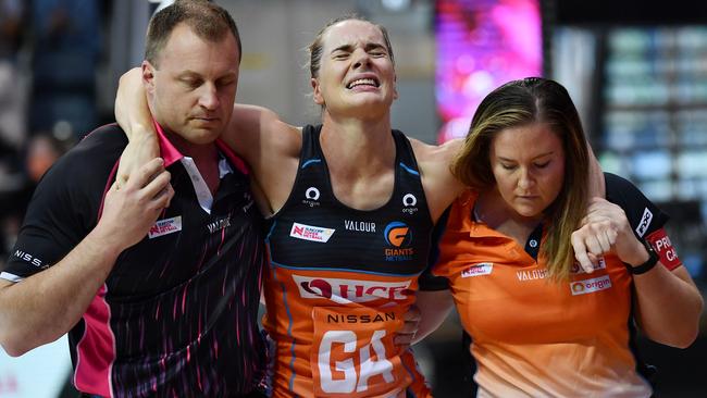 Kiera Austin is helped off the court after injuring her knee during the round one Super Netball match in 2021. Picture: Mark Brake/Getty Images