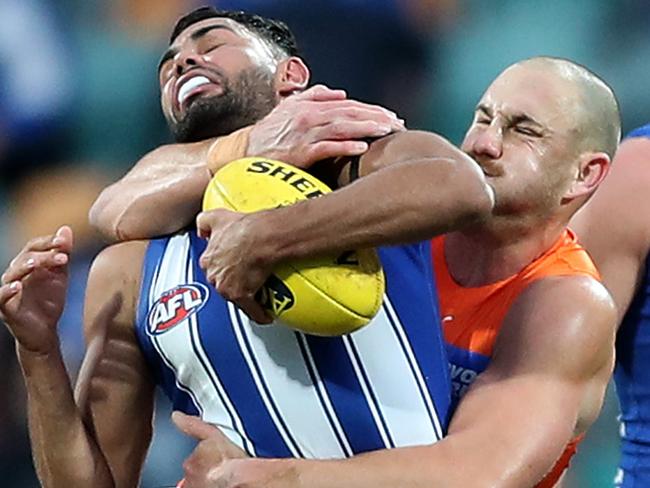 HOBART, AUSTRALIA - JUNE 13: Tarryn Thomas of the Kangaroos is tackled by Shane Mumford of the Giants during the round 13 AFL match between the North Melbourne Kangaroos and the Greater Western Sydney Giants at Blundstone Arena on June 13, 2021 in Hobart, Australia. (Photo by Mark Metcalfe/AFL Photos/via Getty Images)