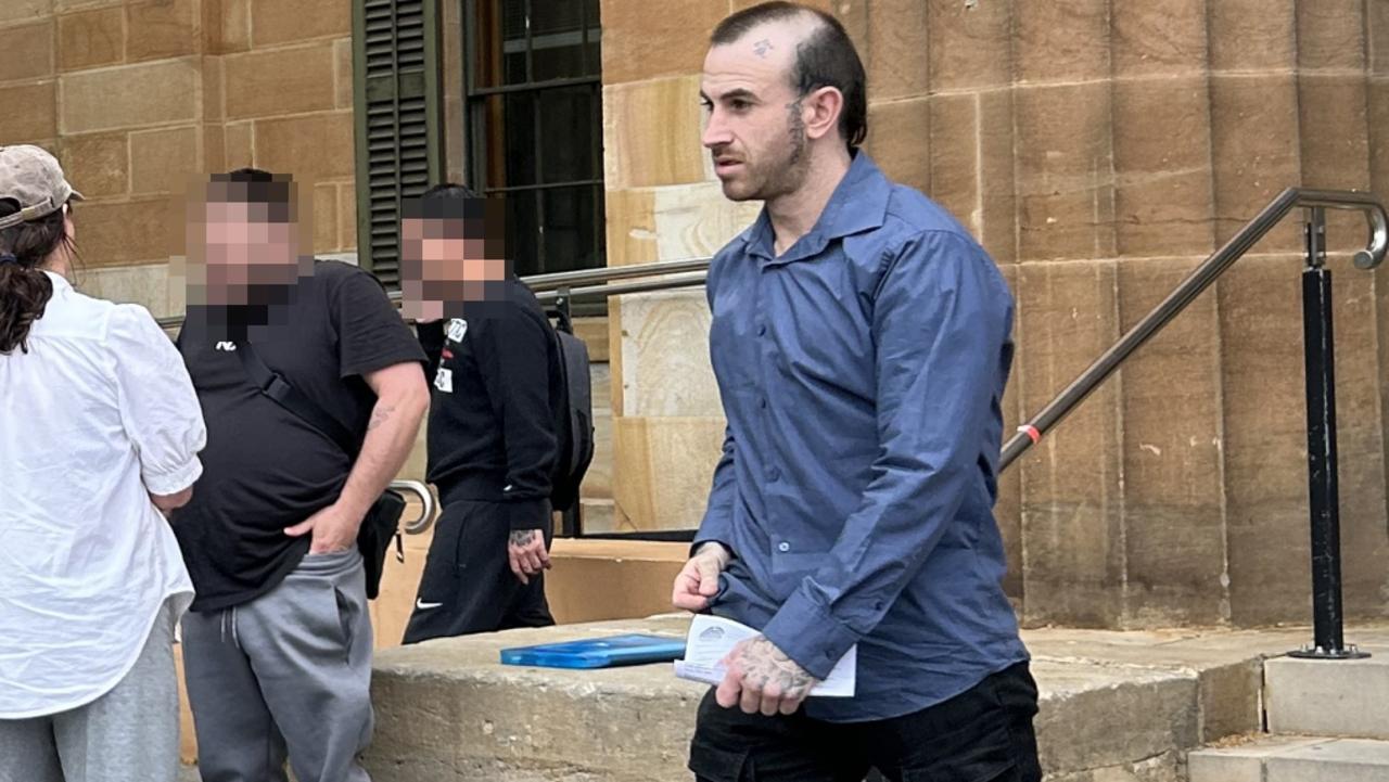 One of the alleged members of a criminal group, right, outside Adelaide Magistrates Court on Wednesday.