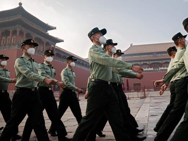 (FILES) In this file photo taken on May 21, 2020 People's Liberation Army (PLA) soldiers march next to the entrance to the Forbidden City during the opening ceremony of the Chinese People's Political Consultative Conference (CPPCC) in Beijing. - The Chinese military is pressing to double its 200-plus nuclear warheads within a decade with the ability to launch them aboard ballistic missiles by land, sea and air, the Pentagon said in a report September 1, 2020. (Photo by NICOLAS ASFOURI / AFP)