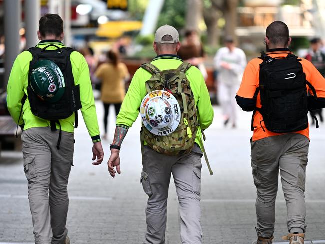 BRISBANE, AUSTRALIA - NewsWire Photos - AUGUST 31, 2022.Construction workers walk through Brisbane's CBD at the end of their work day. Queensland Education Minister Grace Grace has announced a new $10 million pilot program to boost the number of industrial technology and design (ITD) teachers, which will support tradies to become teachers in state schools.Picture: NCA NewsWire / Dan Peled