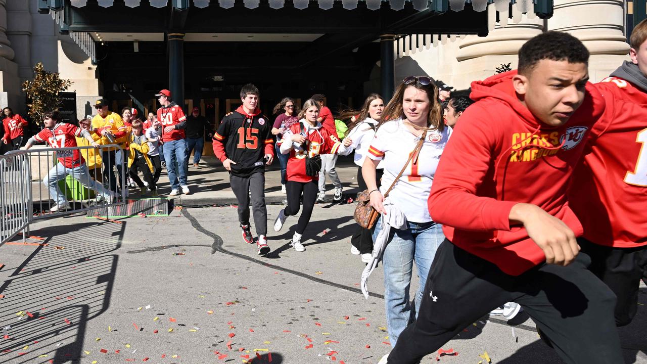 People fled after shots were fired at the parade. Picture: ANDREW CABALLERO-REYNOLDS/AFP