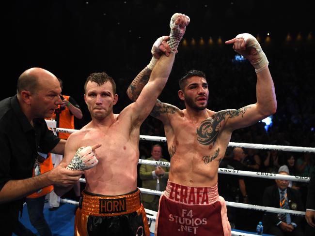 Australian boxer Michael Zerafa holds Jeff Horn's arm aloft after Horn was declared the winner. Picture: AAP