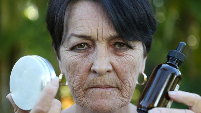 Medicinal cannabis campaigner Deb Lynch with her cannabis oil she uses to treat her various ailments. Picture: Glenn Hampson