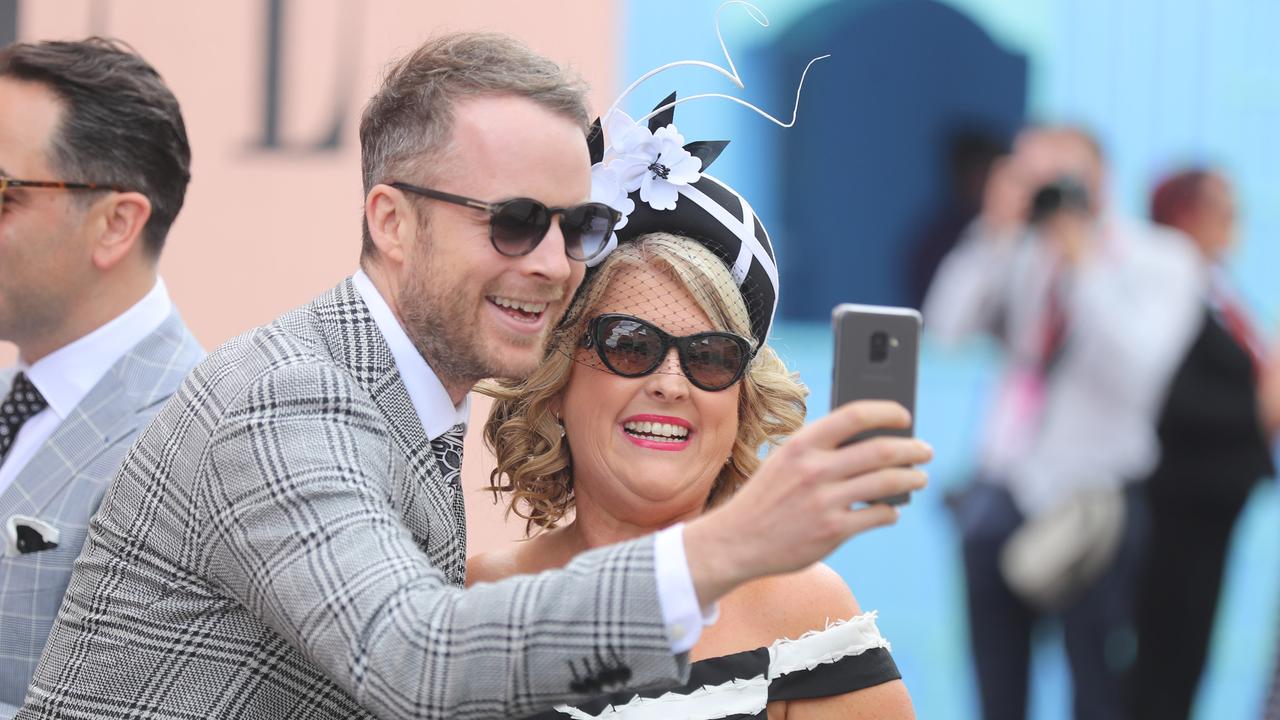 A dapper Hamish Blake pauses for a selfie at Derby Day. Picture: Alex Coppel