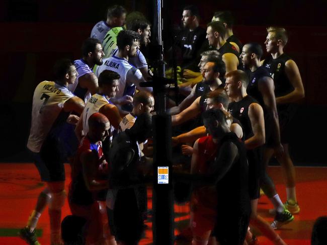 Russia and Canada come together to shake hands before their volleyball quarter-final.