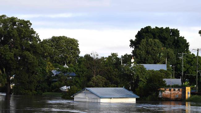 A submerged shed is seen on the bank of the Clarence River in Grafton on March 1, 2022. (Photo by SAEED KHAN / AFP)