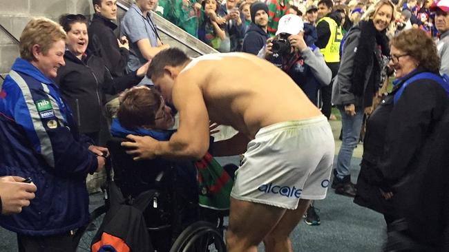 All class: Sam Burgess gives his jersey to a Knights fan.