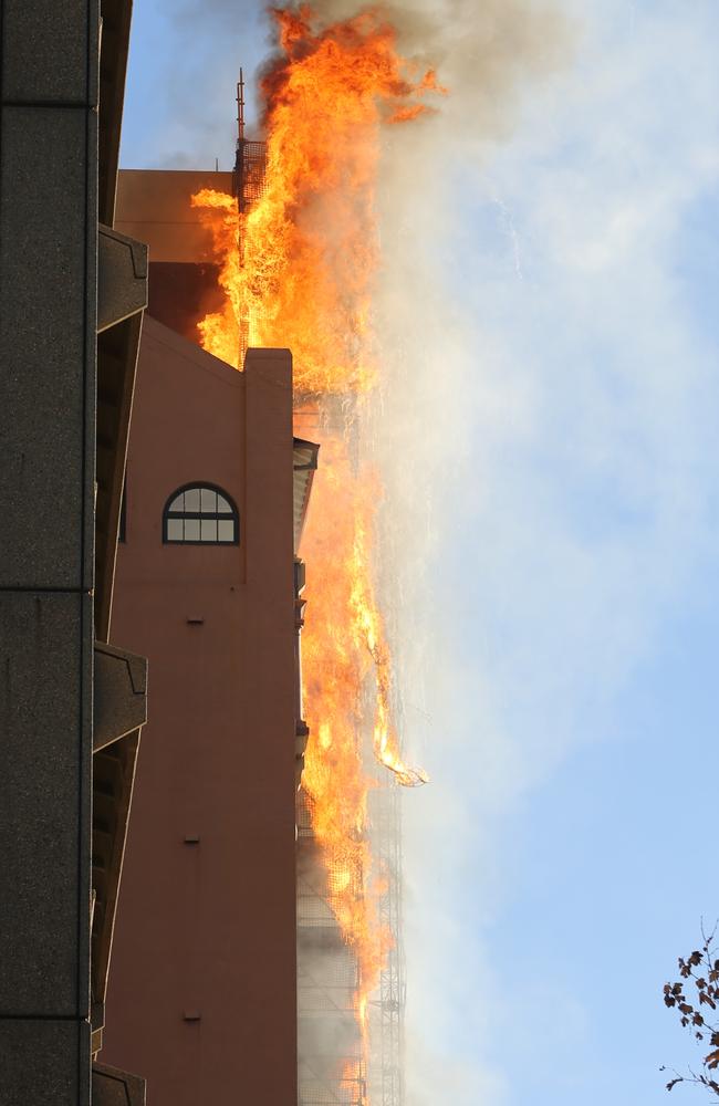 The scaffolding equipment on the building went up in flames. Picture: John Grainger