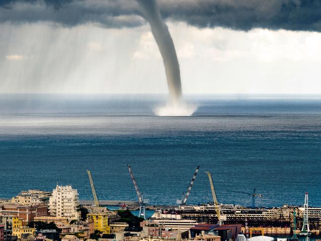 *ONE TIME WEB USE ONLY* *Contact Network for print use* PIC BY EVGENY DROKOV / CATERS NEWS - (PICTURED: The waterspout decends on the bay off the coast of Genoa, Italy.) - These amazing pictures show a TORNADO hitting the coast of an Italian town.The incredible snaps show the stormy skies over Genoa, Italy, as the tornado sweeps over the sea.The dark, blustery clouds filled the sky as the twister pummelled the ocean, with dramatic flashes of lightening and rumbles of thunder. The dramatic pictures were caught on camera by Evgeny Drokov, from Russia, who was on holiday with his family.SEE CATERS COPY.