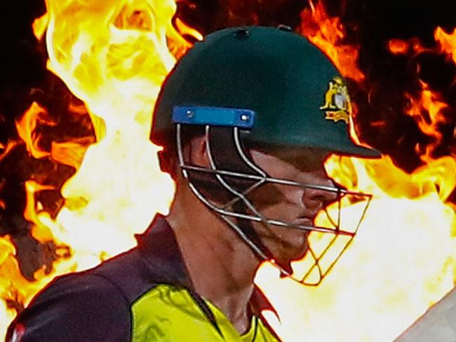 HOBART, AUSTRALIA - FEBRUARY 07:  D'Arcy Short of Australia walks out to bat through flames during the Twenty20 International match between Australia and England at Blundstone Arena on February 7, 2018 in Hobart, Australia.  (Photo by Scott Barbour/Getty Images)