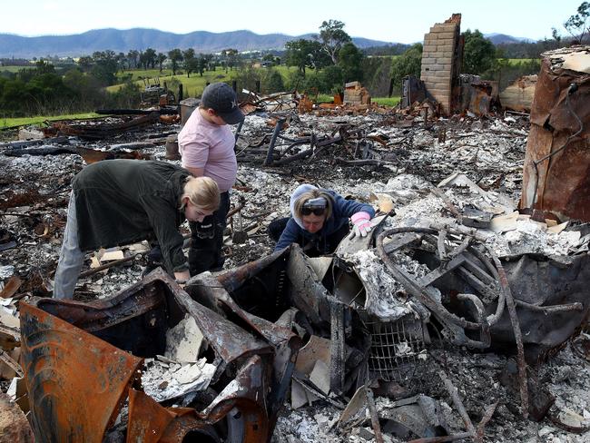 ***EMBARGOED FOR SUNDAY TELEGRAPH***Bushfire recovery on the NSW south coast has begun with the removal of what remained of homes burnt down by the New Year's Eve fires and some locals ready to begin the rebuilding process. Rebecca Sloane and kids Alex and Jack sift through the remains of their burnt down home near Galba, Cobargo before the heavy machinery moved in to clear the rubble. Picture: Toby Zerna