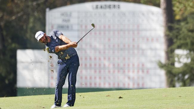 Dustin Johnson hits an approach shot to the 14th hole of a deserted Augusta National Golf Course at last year’s Masters Picture: Getty Images