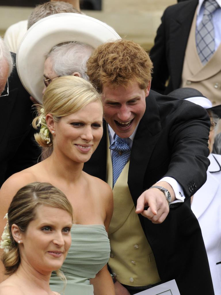 British royal family member Zara Phillips talks to Prince Harry during the wedding of her brother Peter Phillips in 2008.