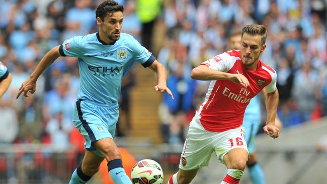 Arsenal's Welsh midfielder Aaron Ramsey (R) chases Manchester City's Spanish midfielder Jesus Navas.