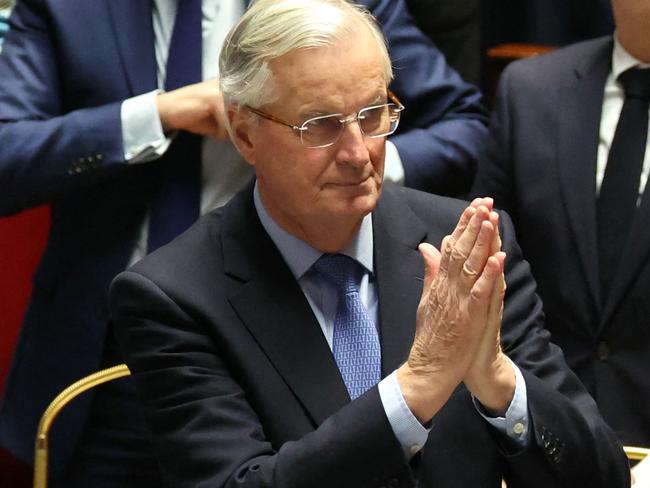 French Prime Minister Michel Barnier gestures after the result of the no-confidence vote on his administration at the National Assembly in Paris on December 4, 2024 as French MPs voted to oust his government after just three months in office in a move which deepens a political crisis in the country. The French National Assembly was voting two motions brought by the French left-wing Nouveau Front Populaire (New Popular Front) NFP coalition and the French far-right Rassemblement National (National Rally) RN party in a standoff over 2025's austerity budget, which saw French Prime Minister force through a social security financing bill without a vote (article 49.3) on December 2, 2024. (Photo by ALAIN JOCARD / AFP)