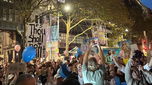 Protesters held up posters, images of Jesus and pink and blue balloons. Picture: Facebook