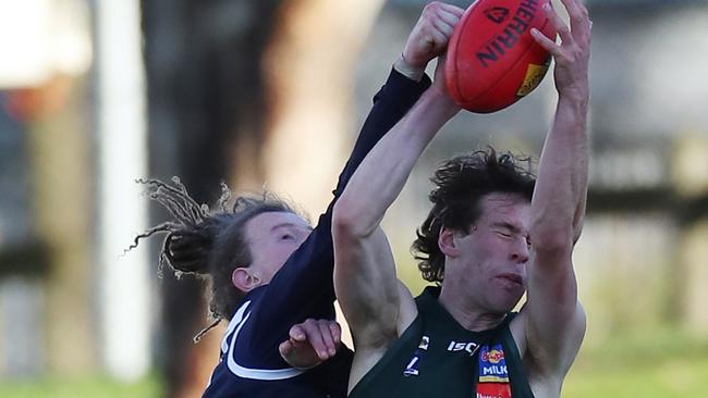Hampden’s Ryley O’Sullivan takes a mark over Ballarat’s Conrad Farrugia. Picture Yuri Kouzmin