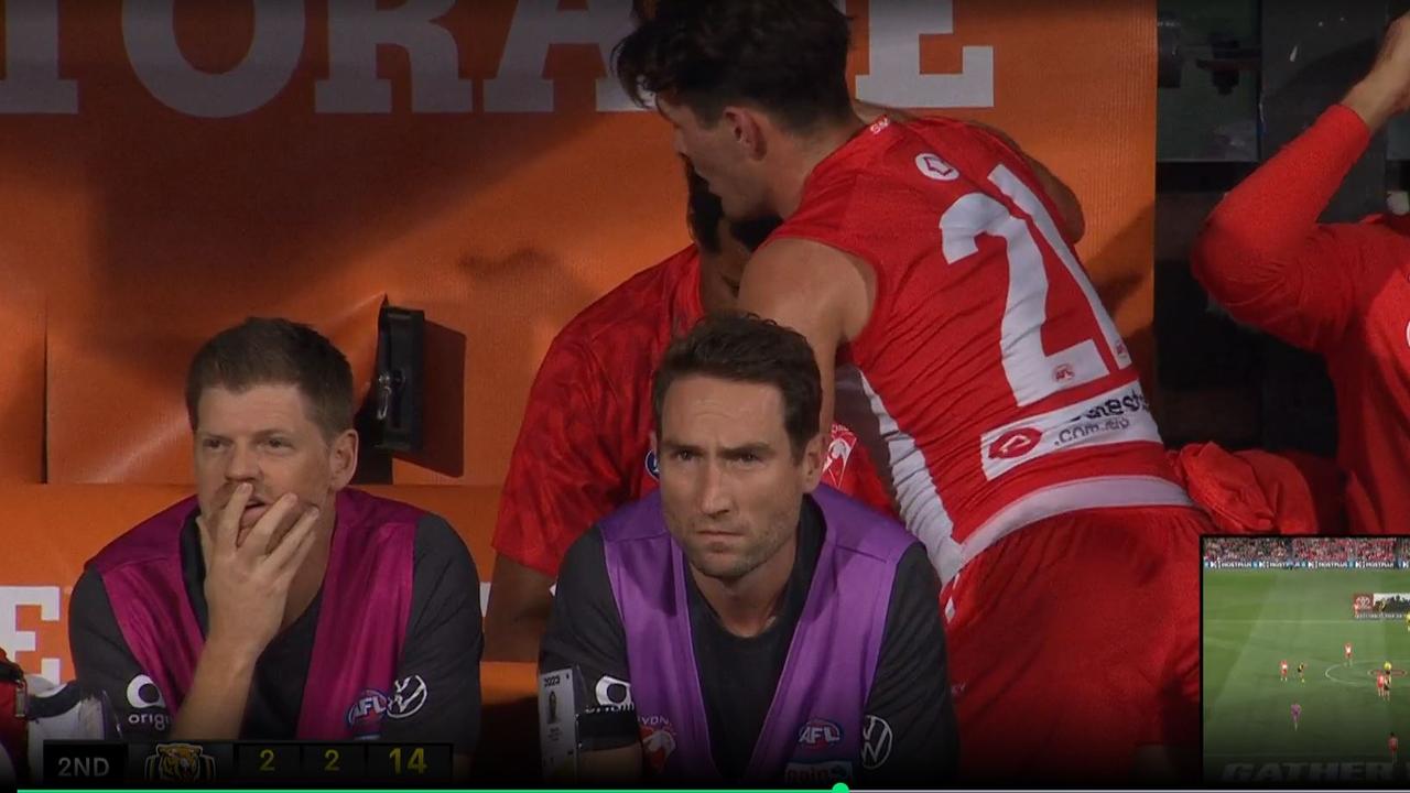 Errol Gulden comforting Joel Amartey after suffering an apparent hamstring injury in Sydney's Gather Round clash against Richmond. Photo: Fox Footy