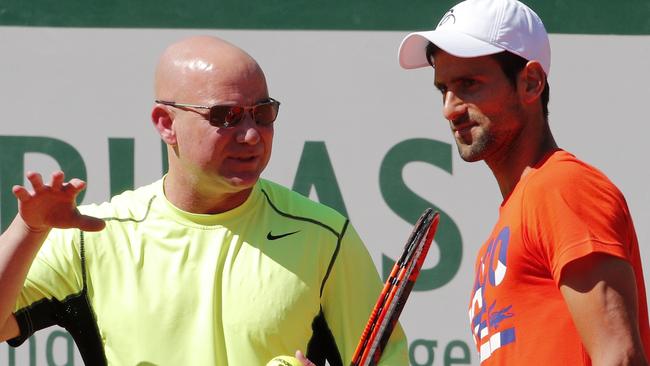 Defending champion Serbia's Novak Djokovic listens to his new coach Andre Agassi.