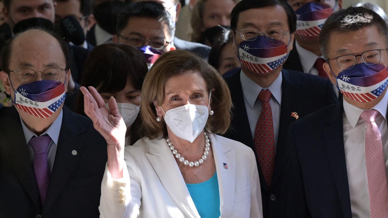 Visiting US House Speaker Nancy Pelosi waves to journalists during her arrival at the Parliament in Taipei. (Photo by Sam Yeh / AFP)