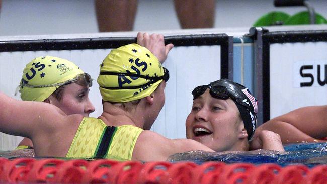 Australians Petria Thomas and Susie O’Neill congratulate US swimmer Misty Hyman on winning the women’s 200m butterfly at the Sydney Olympic Games in 2000. Picture: Brett Costello