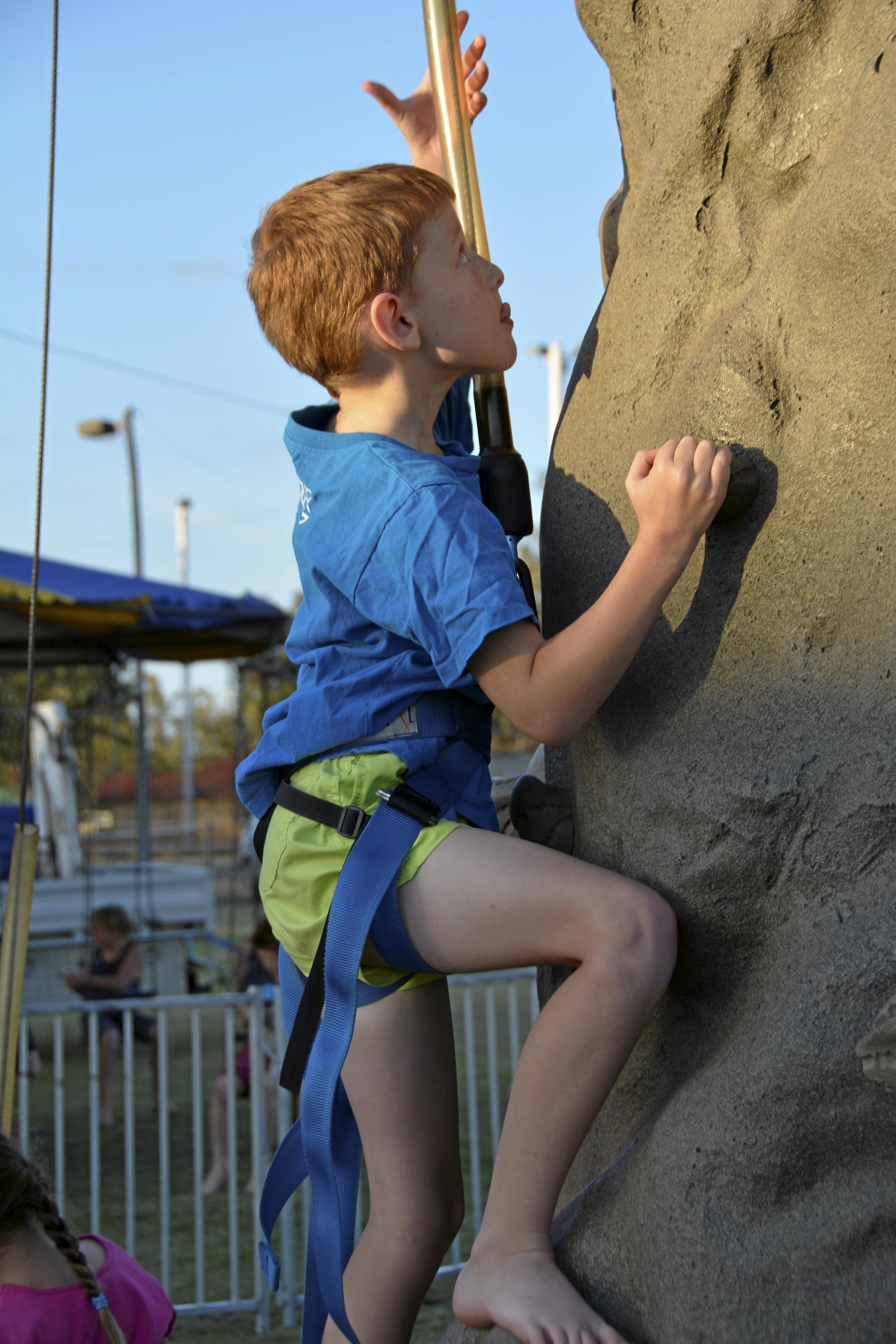 Quillon Klaproth ascends climbing wall at the Tara Christmas Carnival 081218. Picture: Eloise Quinlivan