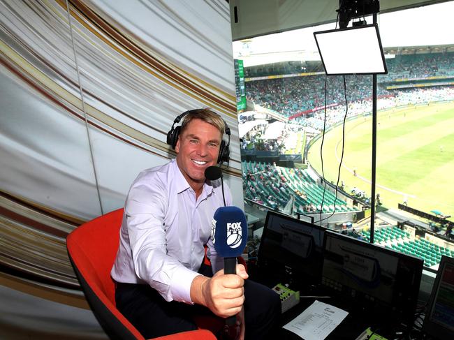 Shane Warne smiling in the commentary box for Fox Cricket. Picture: Phil Hillyard