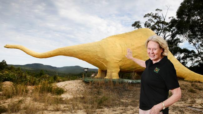 Robyn Weigel, Australian Reptile Park founder, with Ploddy the dinosaur at Somersby. Picture: Peter Clark