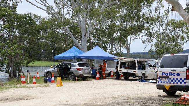 Police divers and Queensland Fire and Emergency Services personnel search the waters off the Lake Tinaroo boat ramp for the body of a 49 year old Atherton man, who was swimming in the lake around 11am Sunday and failed to resurface. Photo: Brendan Radke