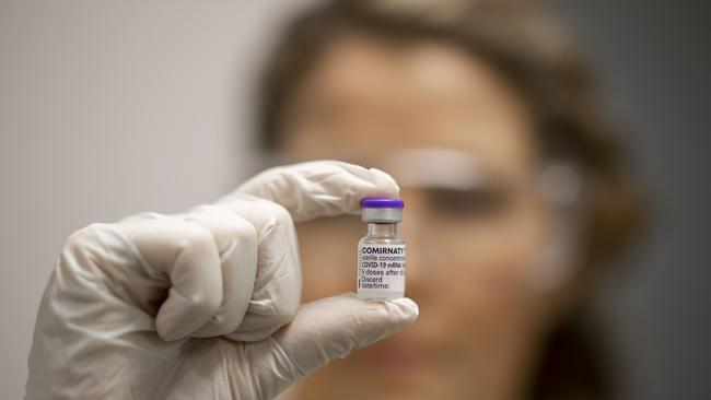 A vial of Covid-19 vaccine is held by advanced pharmacist Rachael Raleigh at Gold Coast University Hospital during the rollout at the start of 2021. Photo by Glenn Hunt/Getty Images.