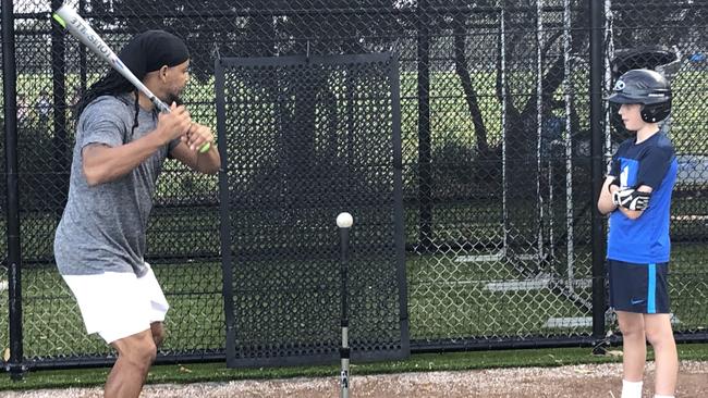 Watch the ball. Manny Ramirez passes on important batting tips at the special training clinic. Picture: Jim O'Rourke