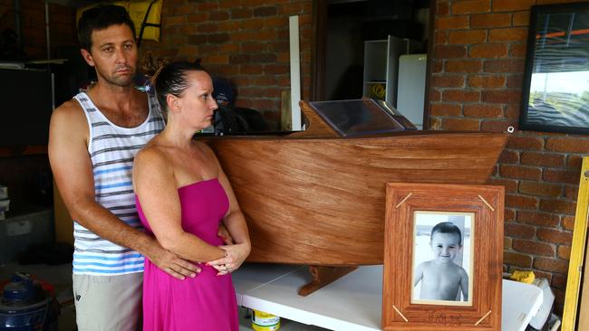 Renee Pask and Shannon Trounce with a photo of son Jax and the boat-shaped coffin the two-year-old was buried in. Photo: David Clark