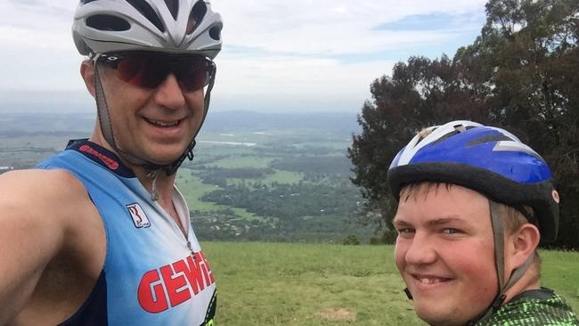 Ky on a bike trip with his dad William. Picture: Supplied