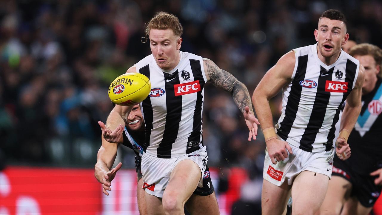 Ryan Burton of the Power chases Beau McCreery of the Magpies. Picture: James Elsby/AFL Photos via Getty Images