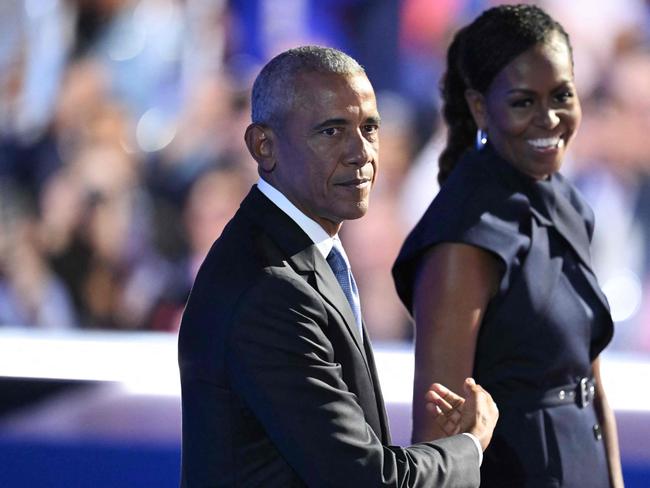 TOPSHOT - Former US President Barack Obama and his wife and former First Lady Michelle Obama stand on stage after she introduced him on the second day of the Democratic National Convention (DNC) at the United Center in Chicago, Illinois, on August 20, 2024. Vice President Kamala Harris will formally accept the partyâs nomination for president at the DNC which runs from August 19-22 in Chicago. (Photo by ANDREW CABALLERO-REYNOLDS / AFP)