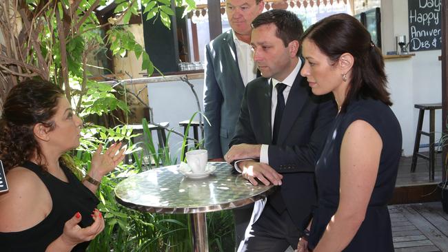 Victorian Leader of the Opposition Matthew Guy is seen with wife Renae Guy, right, Liberal candidate for Frankston Michael Lamb, second left, and cafe owner Mariam Jamil, left, in the Frankston cafe. Picture: AAP