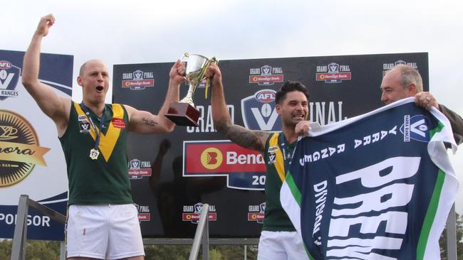 Yarra Junction’s John Holmes and Alan Chandler celebrate with the AFL Yarra Ranges Division 2 flag last season. Picture: Bethany Hutchison