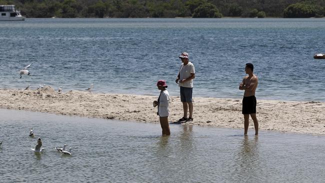 Onlookers at the scene of a Christmas Eve drowning at Ian Dipple Lagoon. Picture: NIGEL HALLETT
