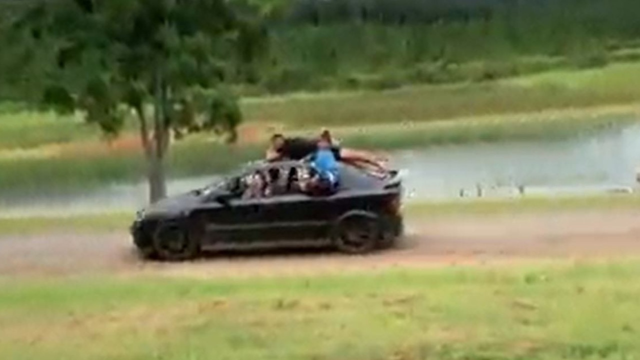 A screenshot of a video showing passengers car surfing at Danbulla State Forest. Dozens of vehicle owners who illegally entered the national park and allegedly caused damage have been caught by Queensland Parks and Wildlife Service. Picture: QPWS