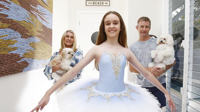 Mark and Marcelle Small with their daughter Elleisha, 12, and the family pets Honey and Libby, at their Mermaid Beach house. Picture: Tertius Pickard