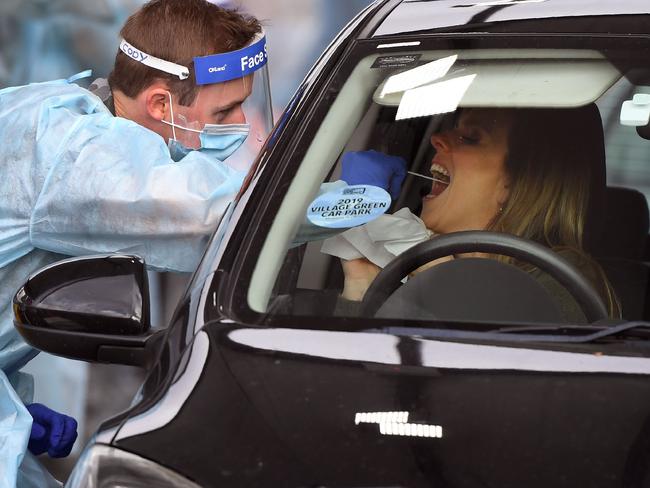 A member of the Australian Defence Force takes a swab sample at a drive-through COVID-19 coronavirus testing station in the Melbourne suburb of Fawkner on July 2, 2020. - Around 300,000 people in Melbourne have to return to lockdown under the threat of fines and arrest as Australiaâs second biggest city attempts to control a spike in virus cases. Health workers went door-to-door in the 36 Melbourne neighbourhoods targeted for lockdown, urging residents to be tested for the coronavirus. (Photo by William WEST / AFP)