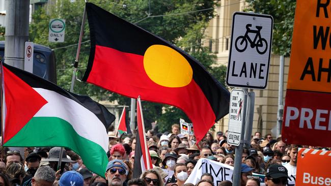 Protesters with Aboriginal and Palestinian flags outside the Victorian Parliament. Picture: NCA NewsWire / Luis Enrique Ascui