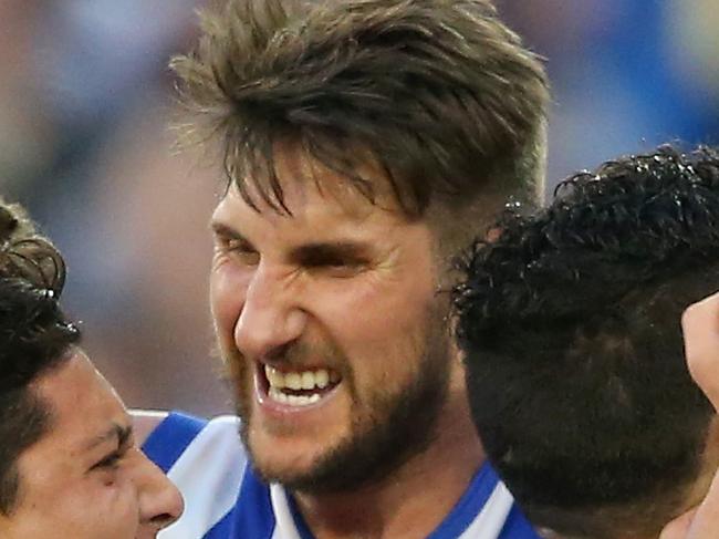 MELBOURNE, AUSTRALIA - SEPTEMBER 13: Jarrad Waite of the Kangaroosis congratulated by team mates after kicking a goal during the First AFL Elimination Final match between the Richmond Tigers and the North Melbourne Kangaroos at Melbourne Cricket Ground on September 13, 2015 in Melbourne, Australia. (Photo by Quinn Rooney/Getty Images)